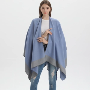 Detailed view of the blue and grey double-sided cashmere-like shawl worn by a model