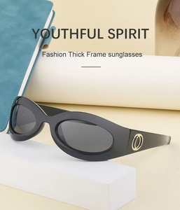 Detail view of black thick frame Y2K sunglasses with gold metal ring on temple