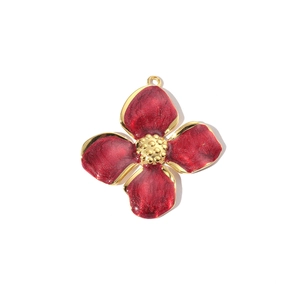Detailed view of a red enamel four-petal flower pendant with gold-plated stainless steel edges