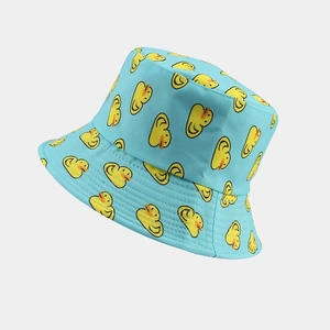 Close-up of light blue bucket hat with yellow duck pattern and stitched brim