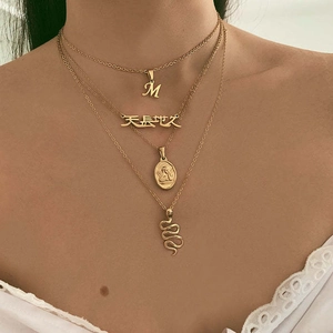 Layered gold titanium steel necklace featuring M letter and angel relief pendants