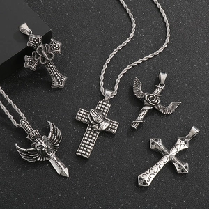 Detailed view of gothic lion sword and rose cross wing pendants in silver stainless steel