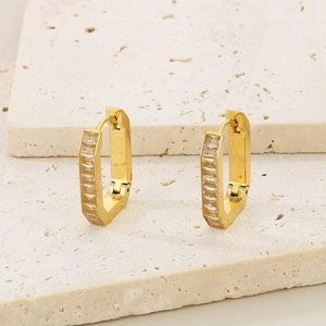 Detailed view of gold geometric hoop earrings with rectangular cubic zirconia stones