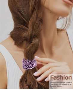 Detailed view of purple beaded hair scrunchie worn on ponytail for fashion styling
