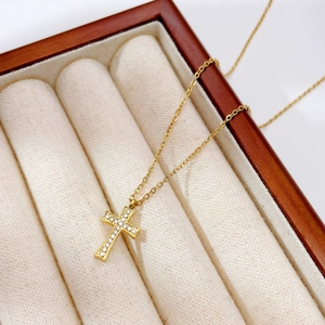 Collier avec pendentif croix dorée sertie de zircons blancs dans un coffret cadeau à bijoux