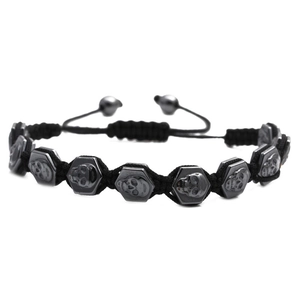Adjustable woven black nylon bracelet with hexagonal skull hematite beads on white background