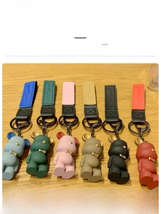 Detailed set of six colorful Nordic bowtie bear keychains with faux leather straps