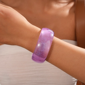 Detail of purple resin bracelet featuring sparkling glitter and smooth glossy finish