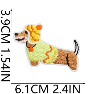 Detailed view of dachshund embroidery patch wearing a yellow hat and green sweater