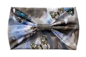 Detail of blue-grey butterfly print headband with soft elastic fabric and bow design