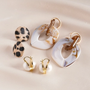 Detail view of 3 pairs of bohemian earrings featuring leopard print and marble textures