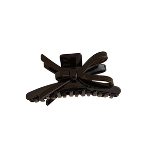 Elegant black acetate bow claw clip with high-gloss finish for women's hair styling