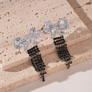 Detailed macro of zircon butterfly earrings with five rows of hanging black stone tassels
