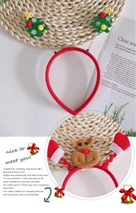 Close-up of festive Christmas headband with spring-loaded green tree and reindeer detail