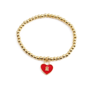 Detail of gold beaded bracelet featuring a red enamel heart-shaped padlock charm