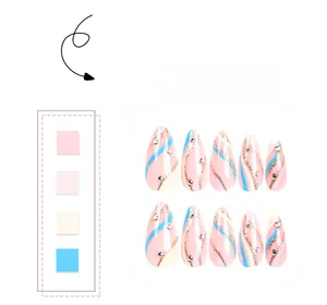 Close-up of pink almond press-on nails with blue glitter waves and rhinestones