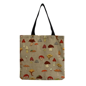 Close-up of the natural linen texture and colorful cartoon mushroom prints on the tote bag