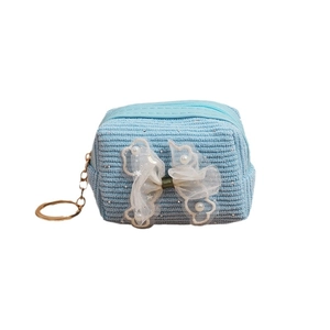 Light blue corduroy mini coin purse featuring a lace bow, pearls, and gold keychain