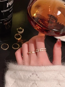 Close-up of S925 sterling silver bow and pearl rings styled on hands for an elegant look
