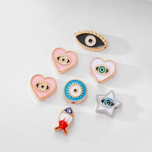 Detailed view of colorful evil eye enamel charms in heart, star, and fish shapes