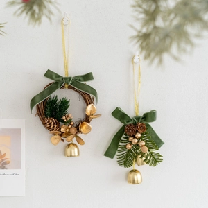Christmas wreath and pendant with green velvet bows, pine cones, and gold bells decor