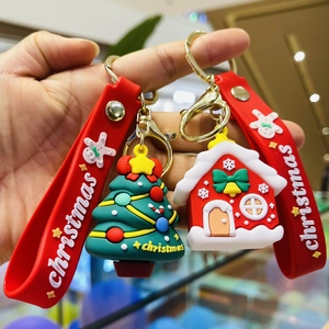 Christmas silicone keychain featuring festive tree and house designs with gold metal ring