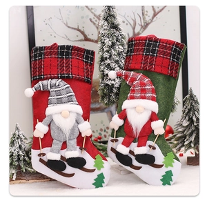 Detail of Christmas gnome stockings with 3D skating doll on white snow surface