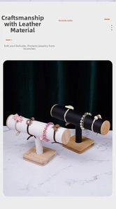 Detail of T-bar jewelry stand with soft leather wrap and natural bamboo wood base