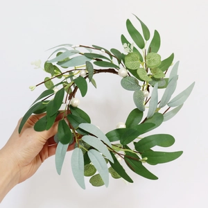 Detail of eucalyptus leaf candle ring with white pearls for wedding scene decoration