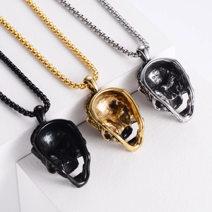 Detailed view of gothic skull pendants in black, gold and silver finishes