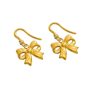 Close-up of 18K gold plated bow earrings with small white zircon stone inlay detail