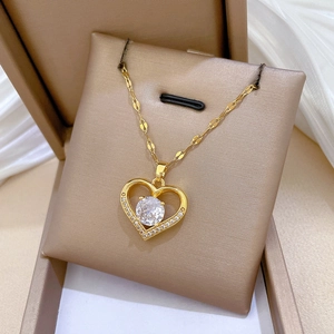 Minimalist heart-shaped gold necklace with round central diamond in a jewelry gift box