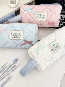 Quilted macaron-colored glossy makeup bags with bows and handles in three colors