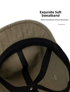 Detailed close-up of the black cotton sweatband inside the khaki baseball cap with stitching