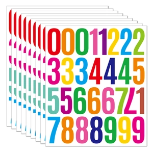 Macro shot of 2-inch colorful vinyl number stickers with a stack of 10 waterproof sheets