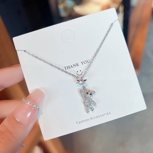 Detailed macro view of silver bear pendant with shimmering pavé rhinestones and star detail