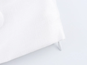 Detailed close-up of invisible zipper and textured white linen fabric on the skirt set