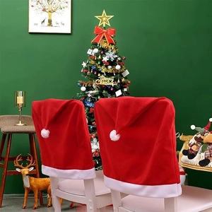 Red and white Santa Claus hat chair covers in a festive Christmas home dining setting