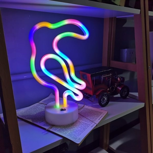 Detailed view of colorful toucan LED neon light on a white base for room decoration