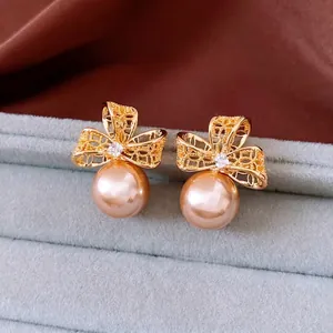 Boucles d'oreilles vintage dorées 18k avec nœud fleur et perles de champagne chic