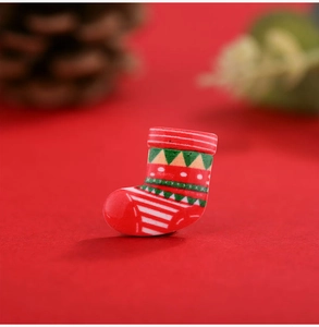 Macro view of Christmas stocking resin charm with red, white and green stripes
