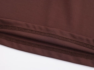 Close-up of brown long sleeve sports top showing high-quality double-needle stitching detail