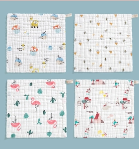 Detail of four ultra-soft cotton baby gauze towels with colorful animal prints