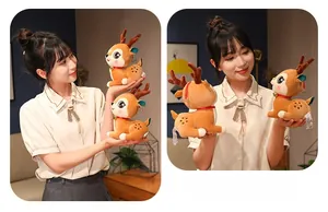 Close-up of plush reindeer toys featuring soft orange fur, white spots, and gold bells