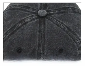Detail of the reinforced stitching and button on top of this washed denim baseball cap