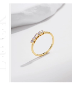 Detail showing S925 hallmark on a thin gold ring band with five moonstone gems