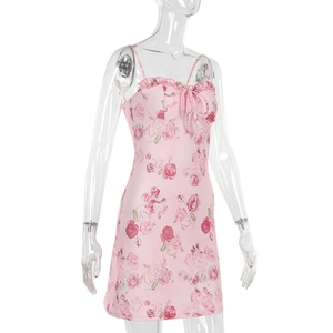 Detalle de vestido floral rosa con escote de volantes y lazo decorativo elegante