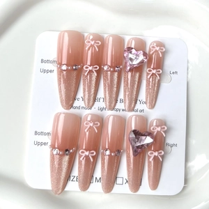 Handmade cat-eye press-on nails with 3D bows and heart crystal in champagne pink