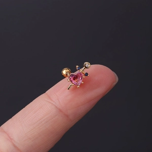 Macro view of heart-shaped pink zircon stud earring with gold-plated spiral ball back