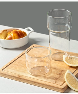 Stackable borosilicate glass cups on a wooden tray for coffee and drinks